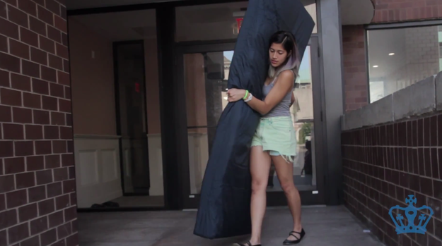 Student carrying mattress