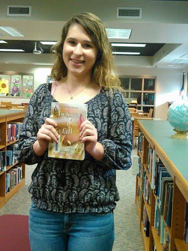 Kaitlyn Burnette (10), eager to read, holds a copy of the novel.