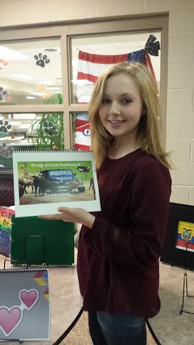 Amber Simberly (11) poses with her children's book for Spanish.