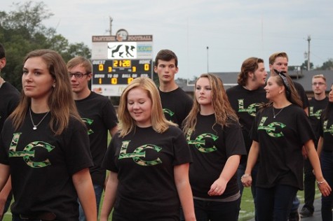 The Singers walk onto the field to sing the National Anthem.