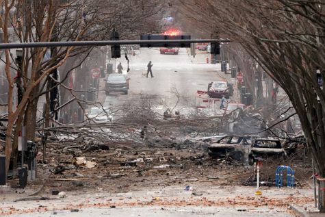 Emergency personnel work near the scene of an explosion in downtown Nashville, Tenn., Friday, Dec. 25, 2020. Buildings shook in the immediate area and beyond after a loud boom was heard early Christmas morning.(AP Photo/Mark Humphrey)