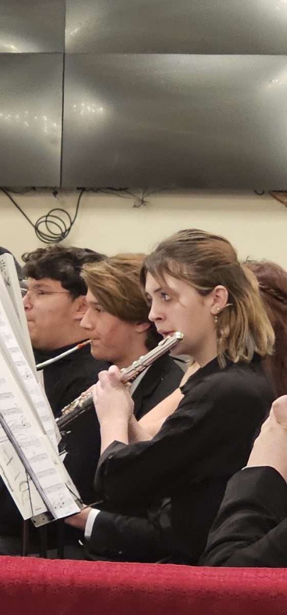 Abby Holm (10) playing the flute in a band performance