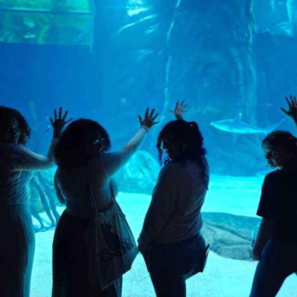 Jaiden Hutto (11) poses with her friends in the aquarium